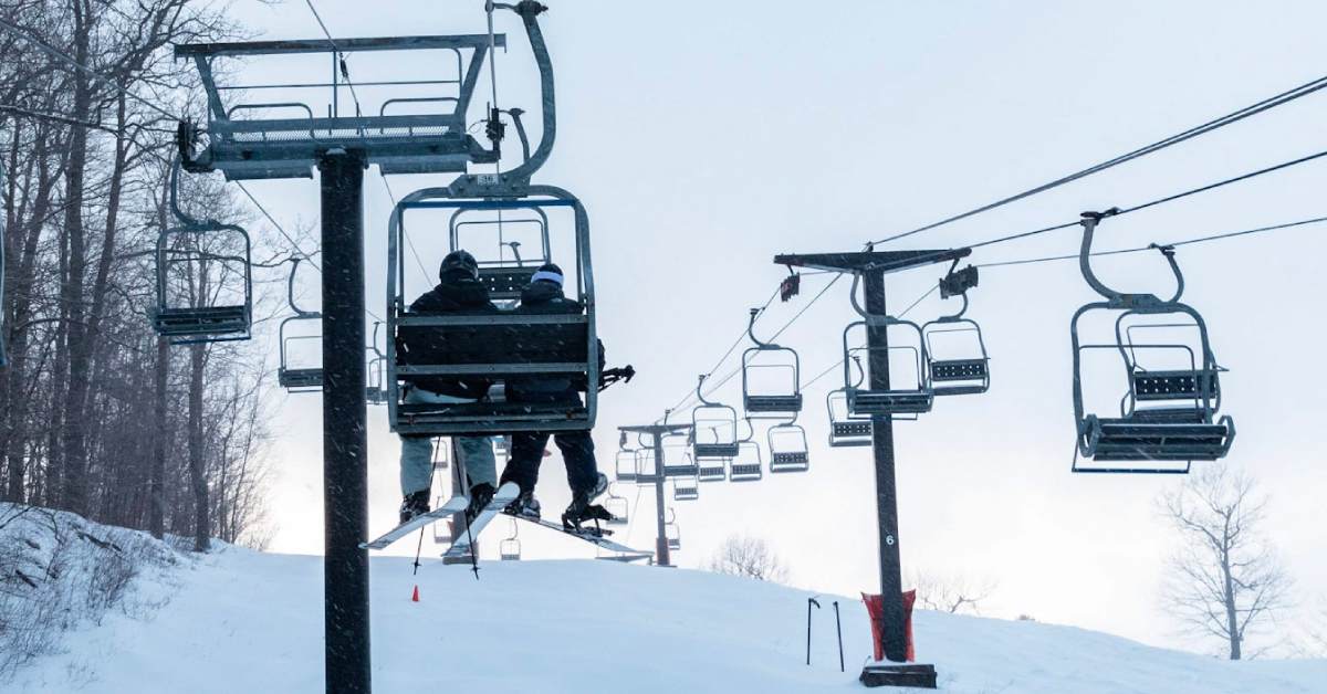 chairlift bringing skiers up a mountain