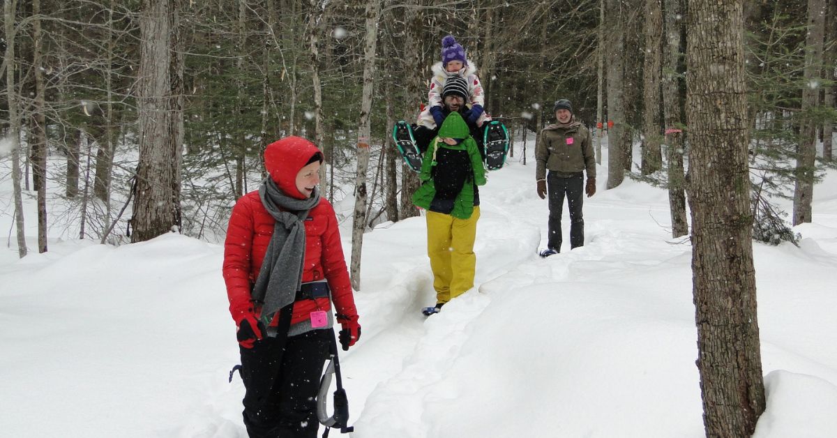 family snowshoes together