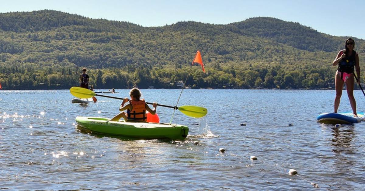 kayakers and standup paddleboarder on lake george