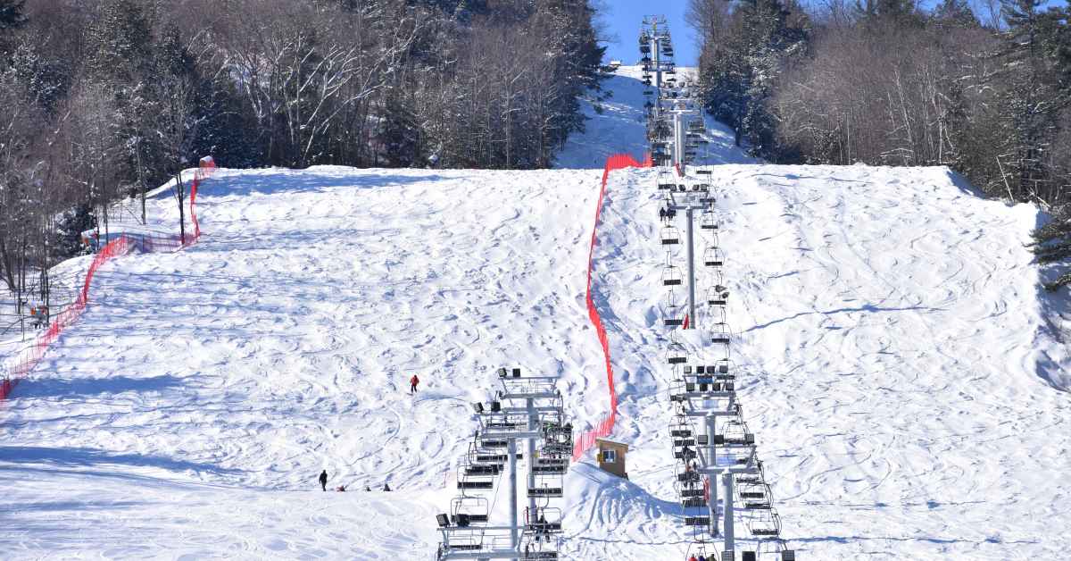 a chairlift leading up a snowy mountain