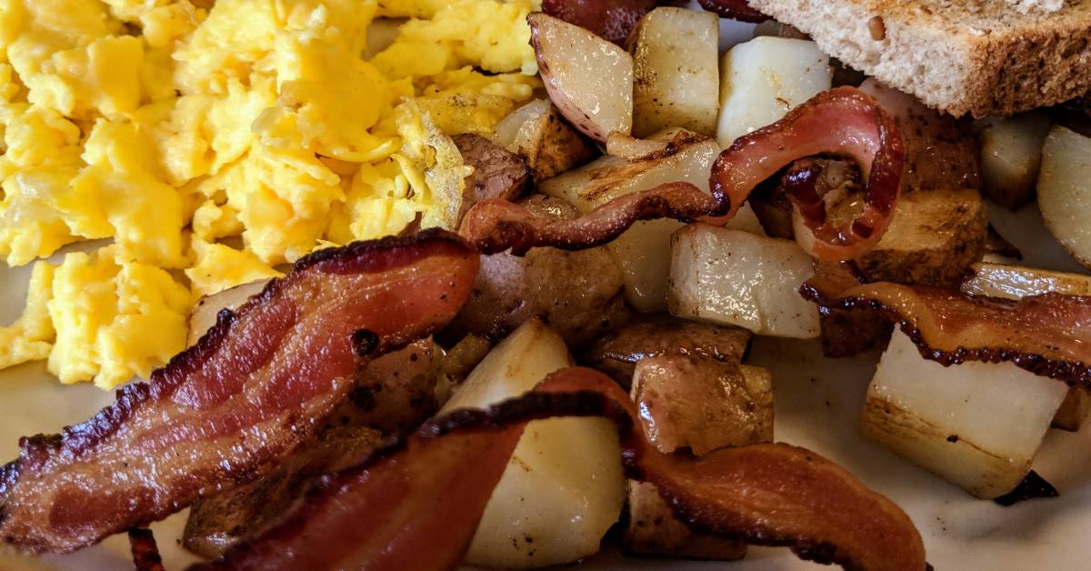 scrambled eggs, bacon, home fries, toast