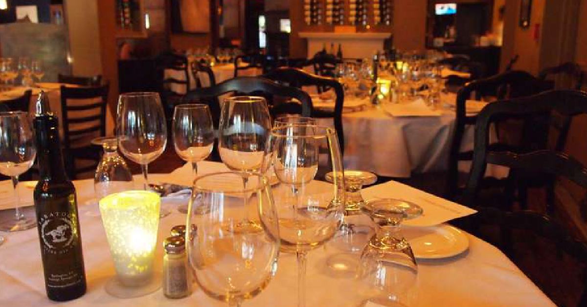 wine & glasses on a set dining room table 