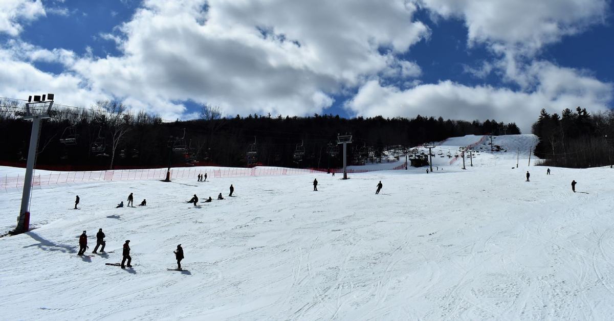skiers moving down a snowy mountain