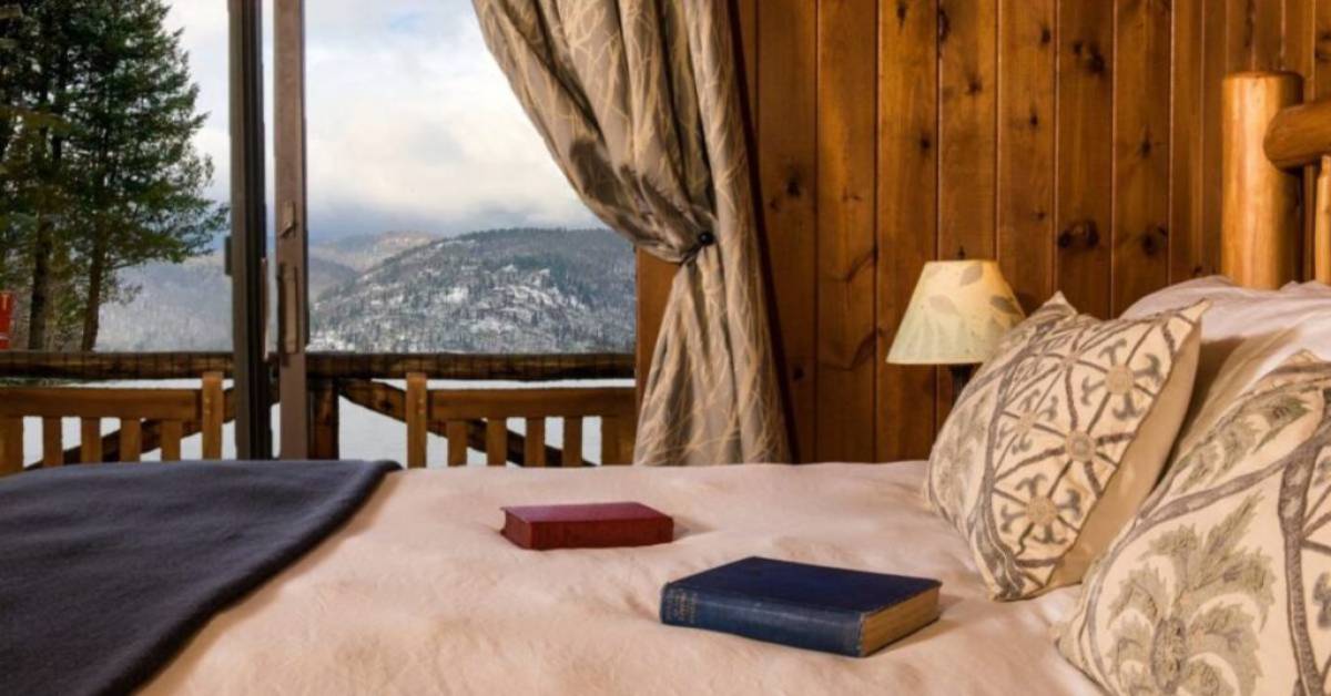 bedroom with window overlooking winter summits