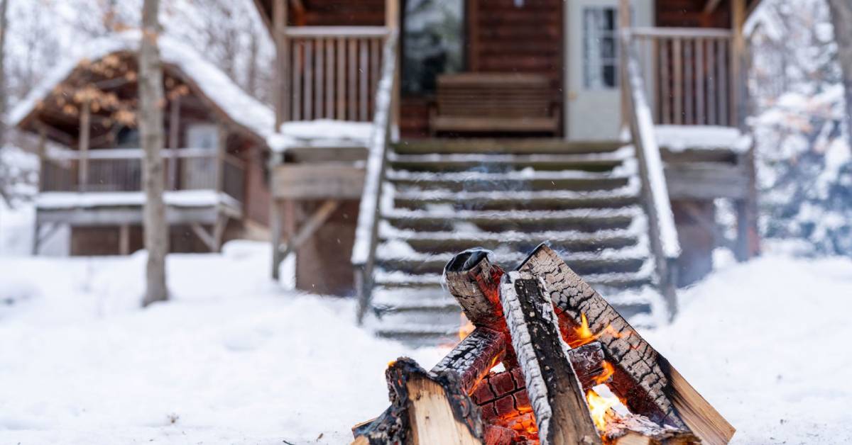 fire in front of winter cabins
