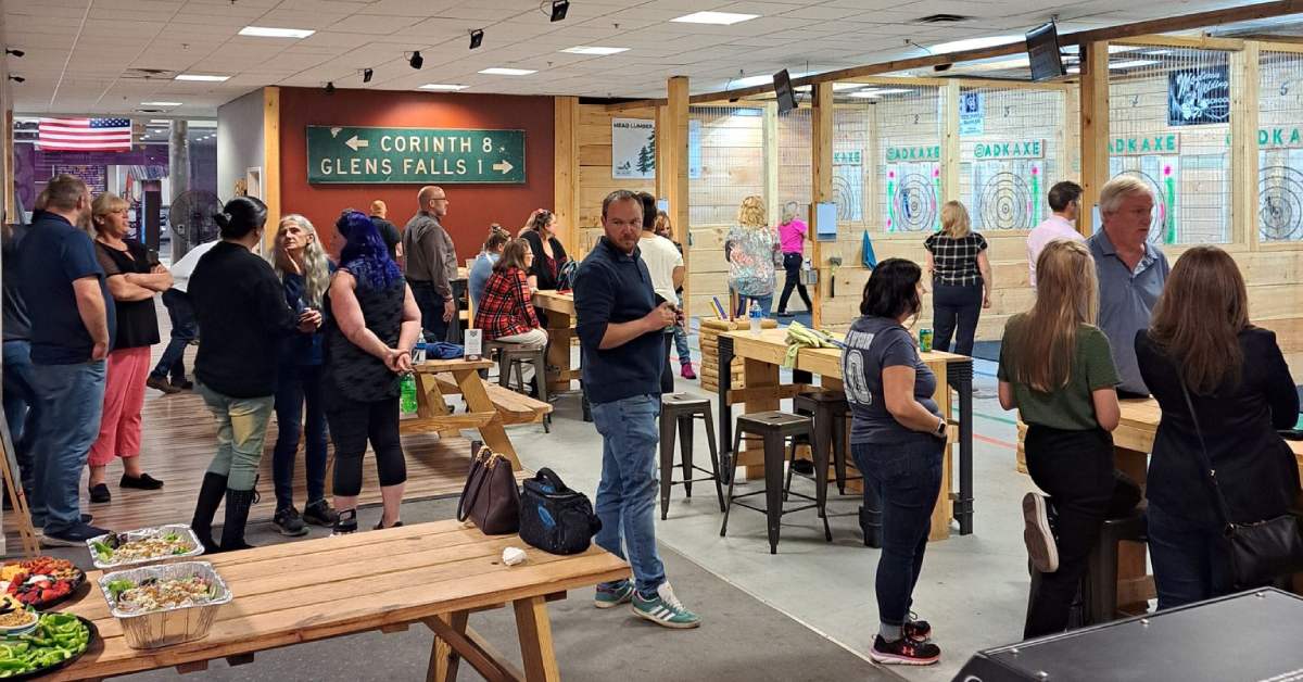 people at an axe throwing venue