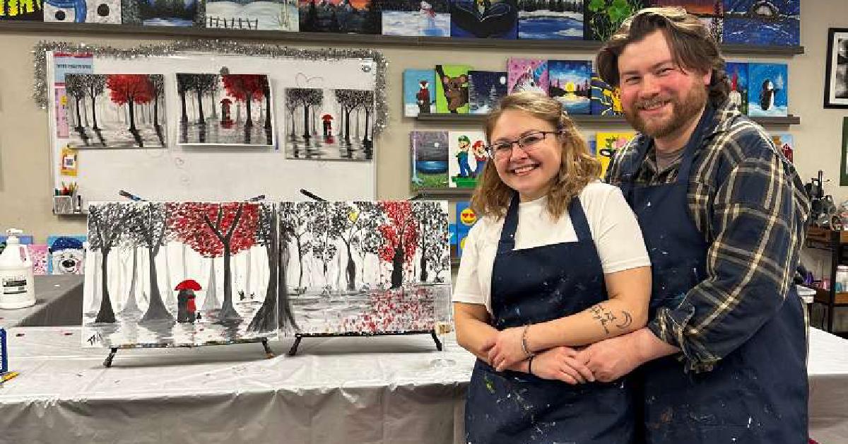 couple smiling at art in mind studio