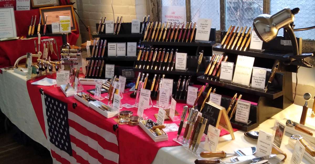 wooden pens for sale at a vendor table