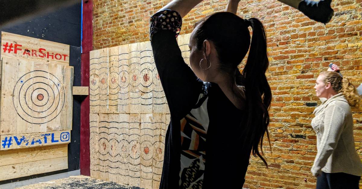 Woman Throwing Axe at Board