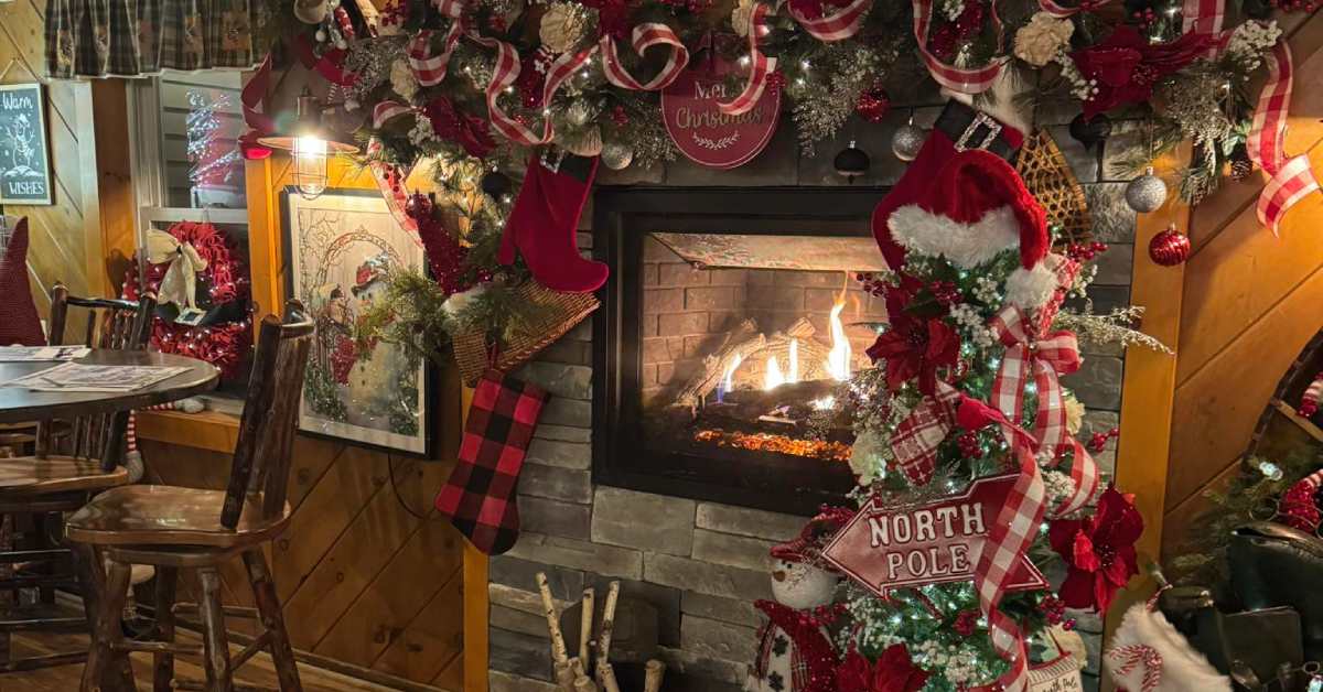 fireplace in a restaurant with Christmas decor around it