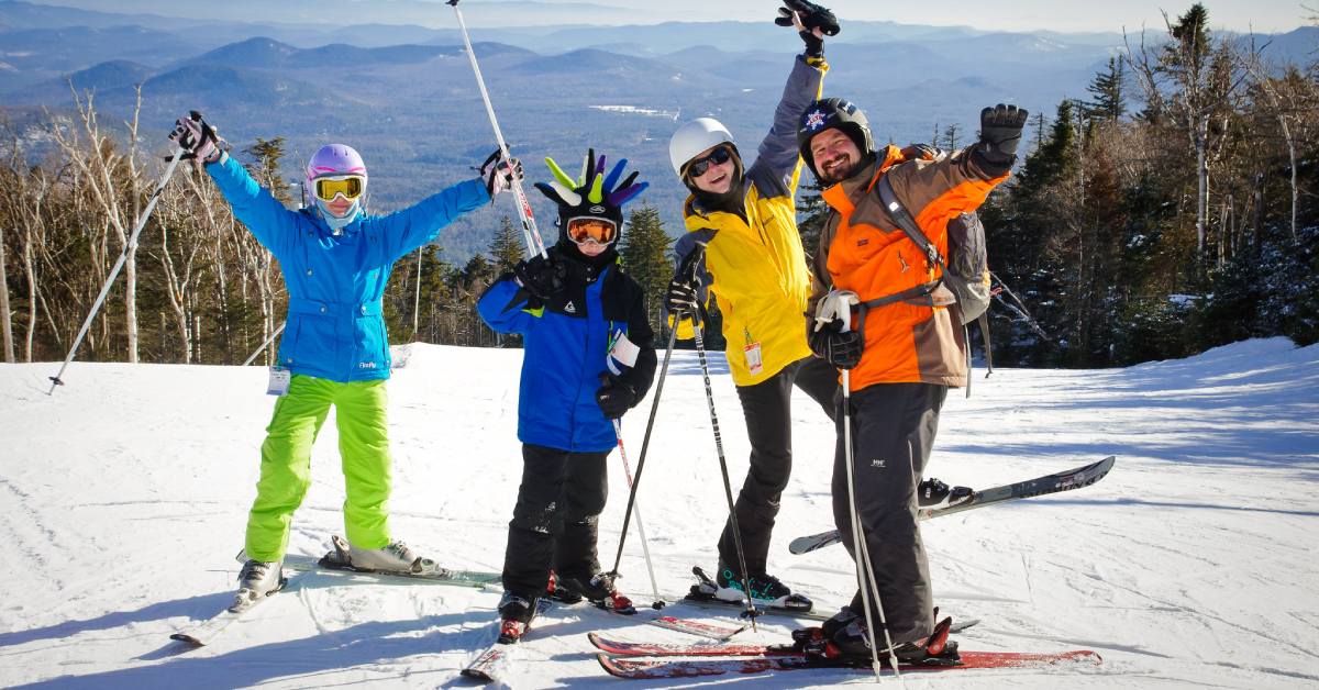 family of four skiers posing