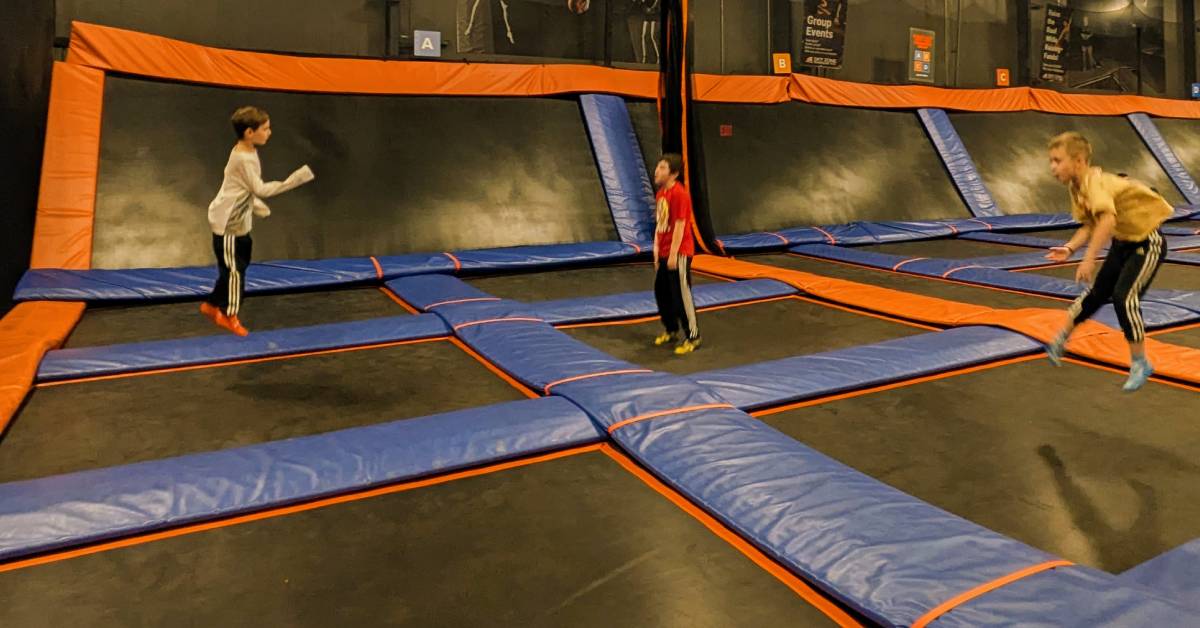 three boys jumping at skyzone queensbury