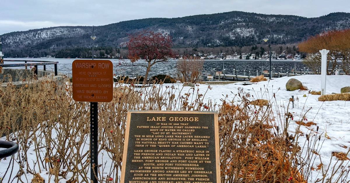lake george sign by lake in winter