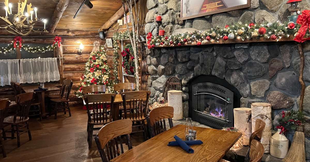restaurant dining area with stone fireplace and holiday decorations
