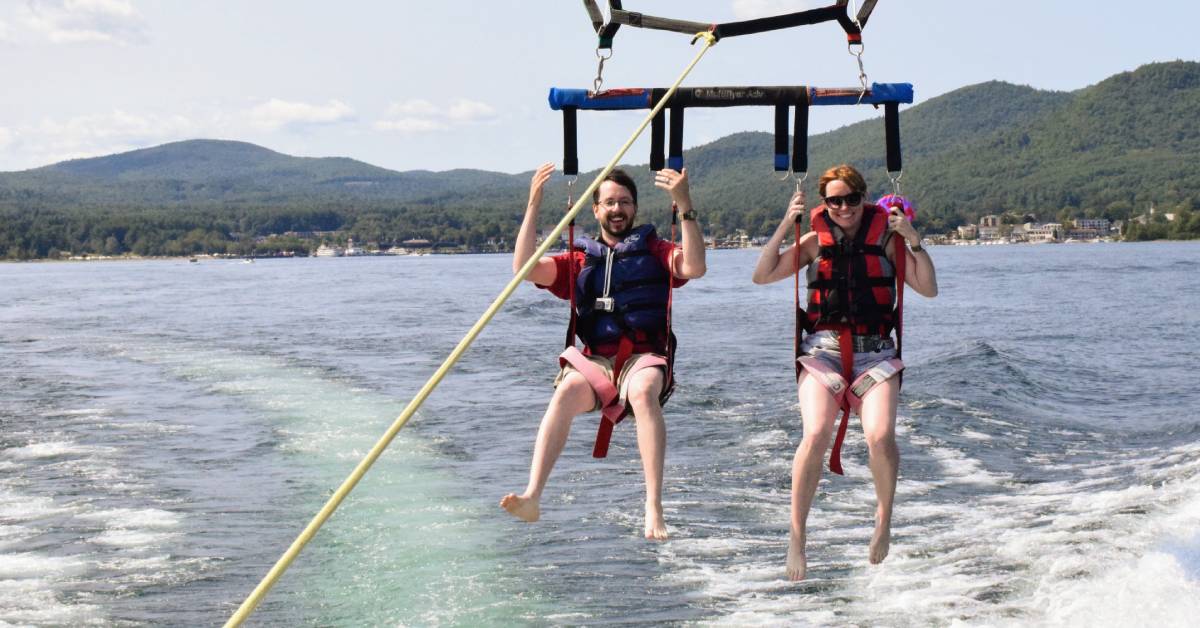 couple parasails over lake george