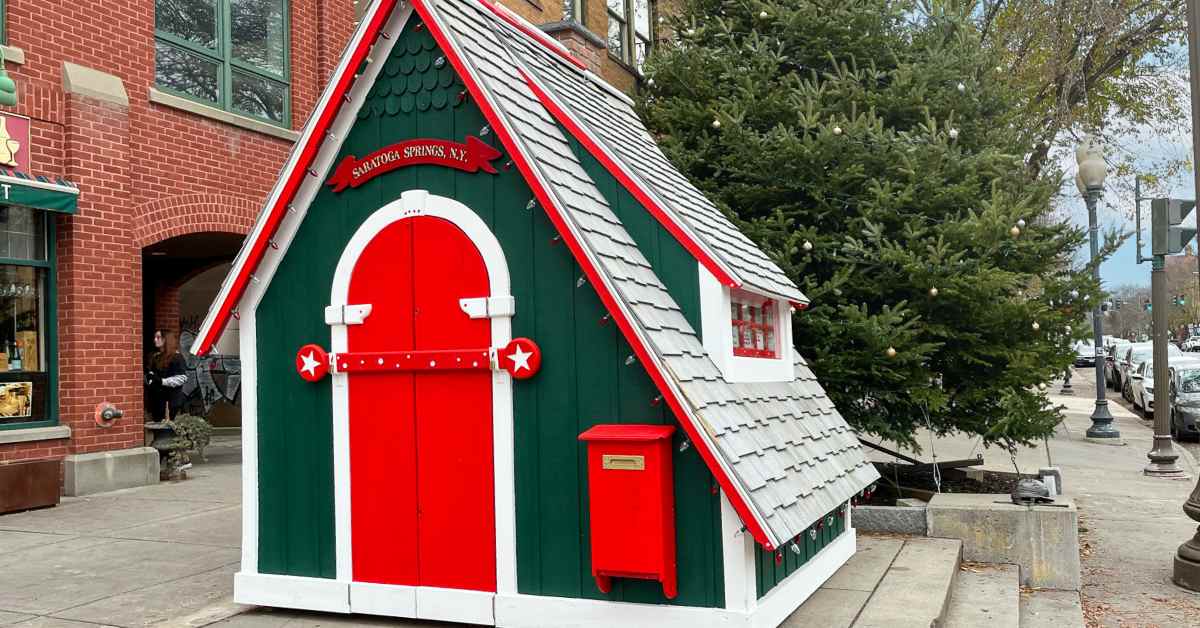 exterior of green and red Santa's Cottage outside a building