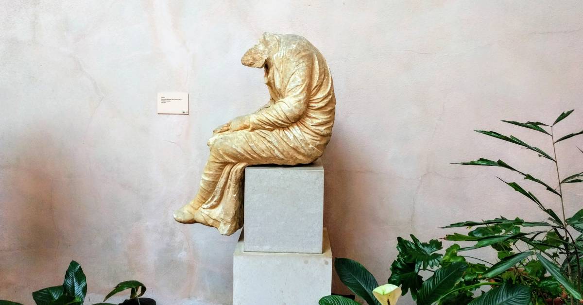 statue of man with no head thinking