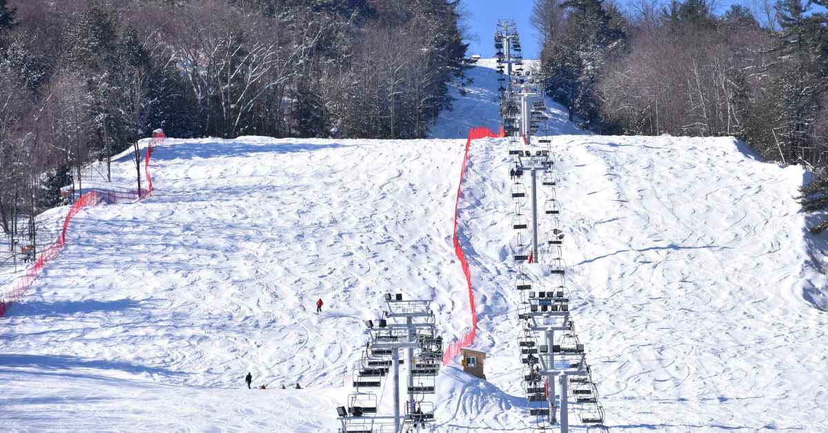 View of snowy ski slopes and chair lift