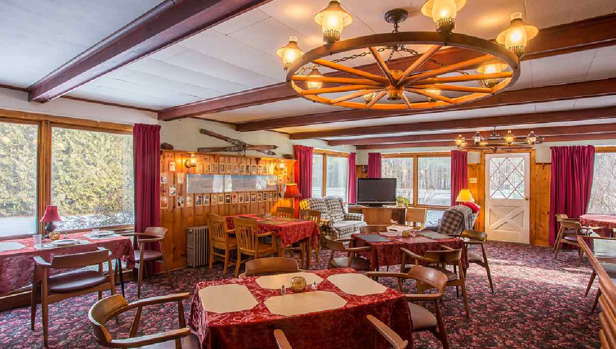 rustic dining room with tables and large light above