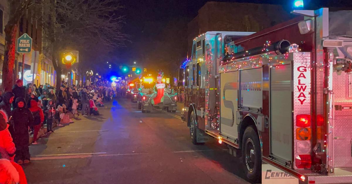 night holiday parade trucks