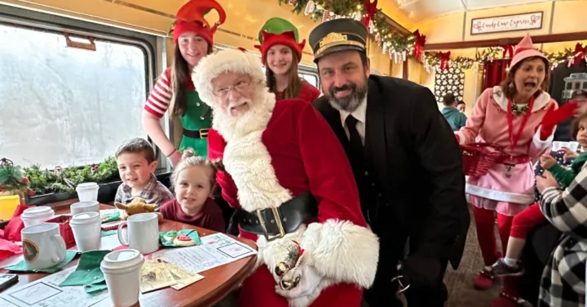santa, conductor, and kids in a train
