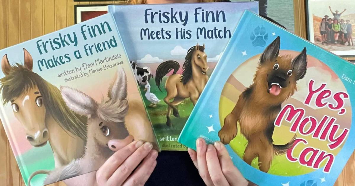 hands holding up three frisky finn books