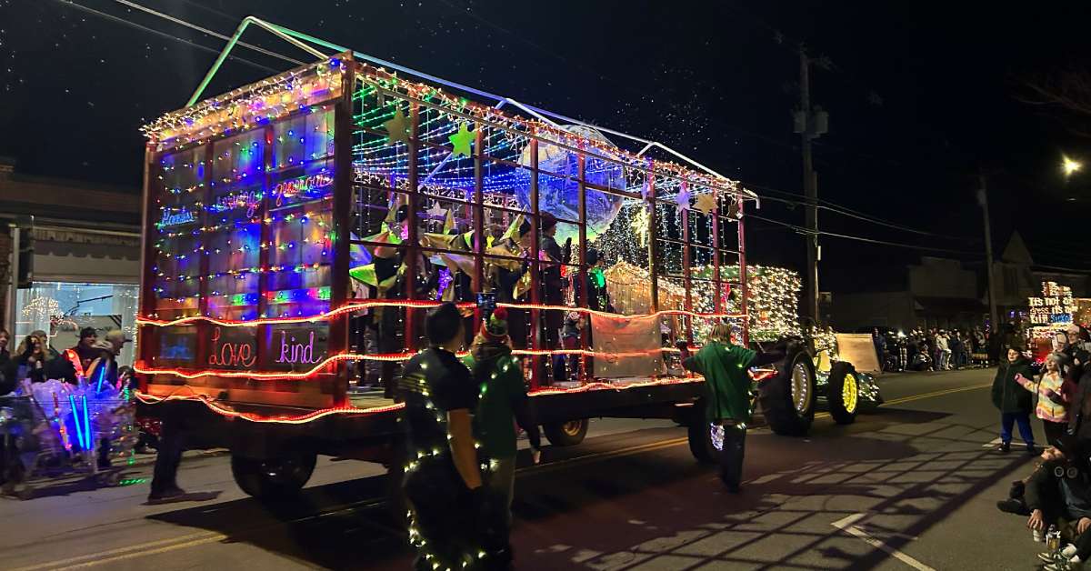 a tractor and trailer decorated with Christmas lights