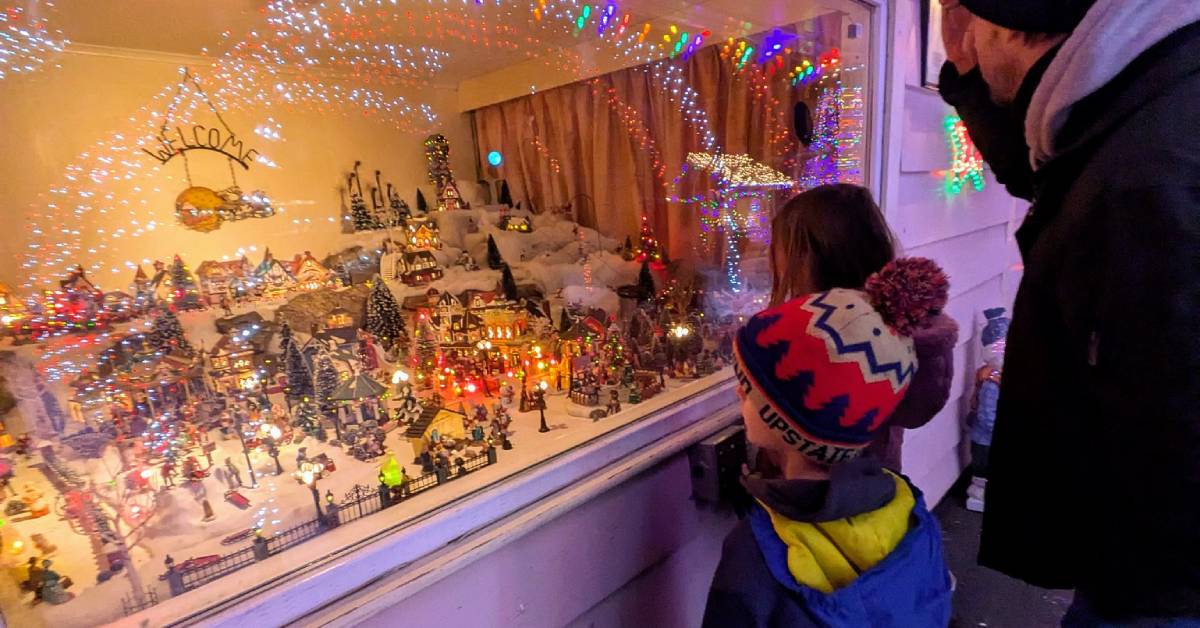 family looks at holiday display at house