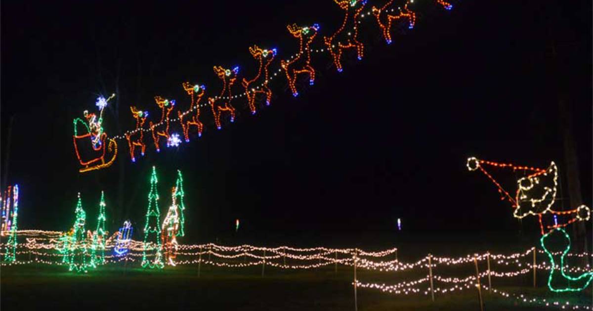 a Christmas scene of holiday lights with Santa and reindeer