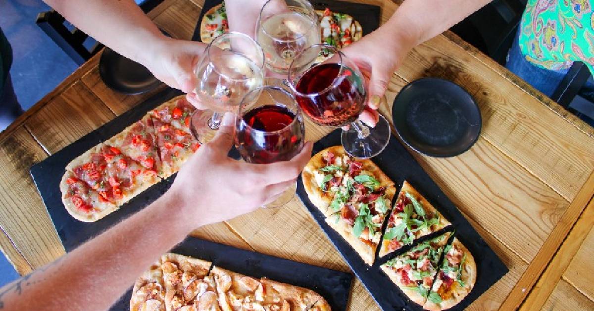 cheersing wine over share plates