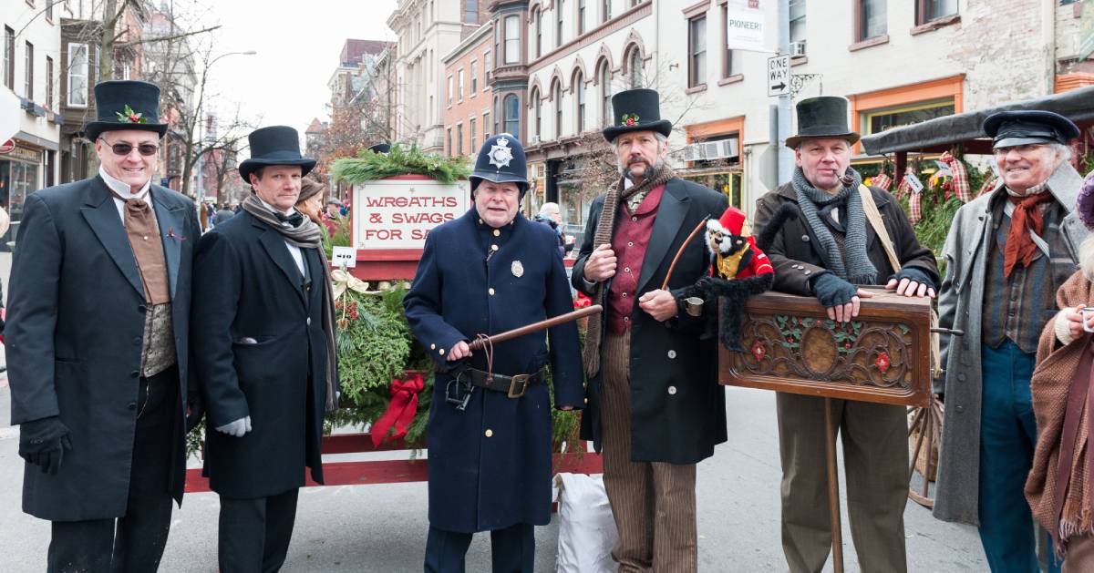 group of men dressed in Victorian outfits for a holiday stroll event