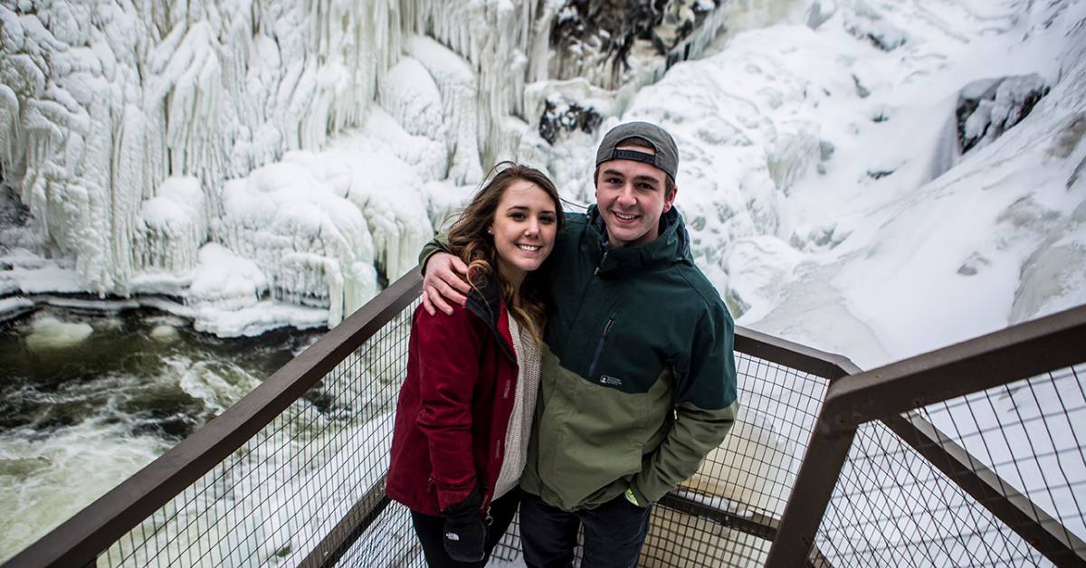 couple poses at high falls gorge in the winter