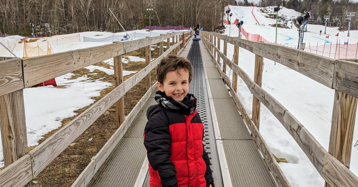 kid at snow tubing park at west mountain