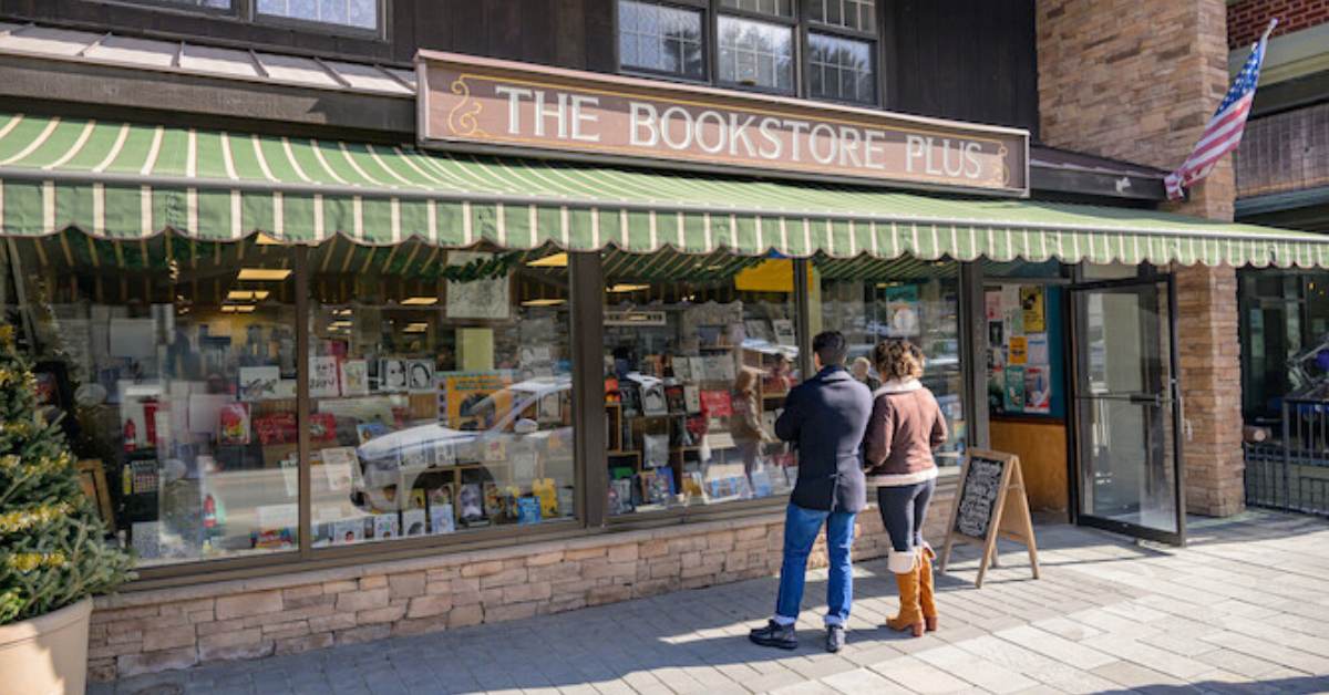 man and woman standing outside a store called The Bookstore Plus