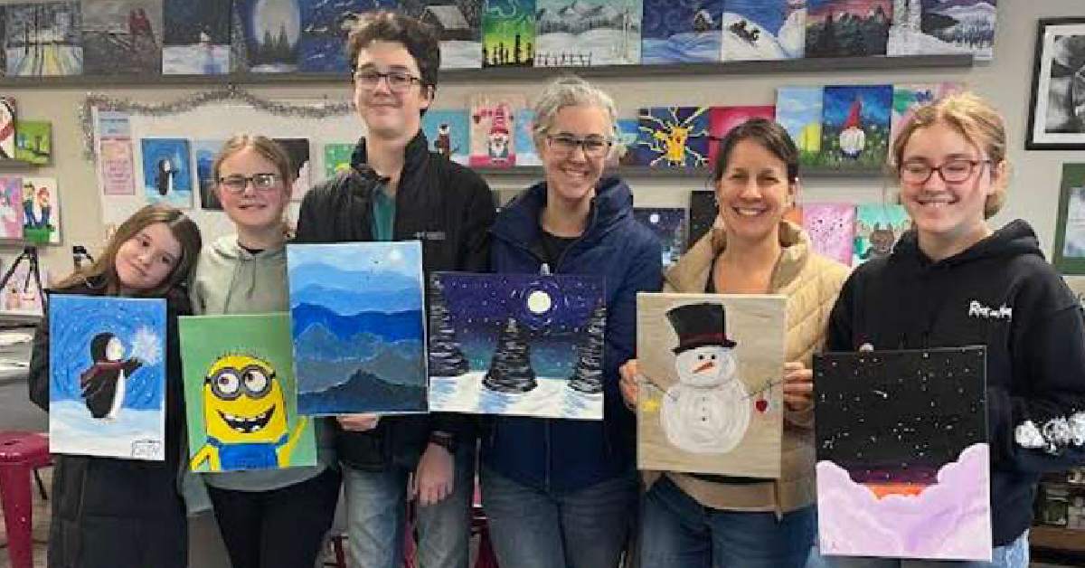 group lined up inside paint and sip studio