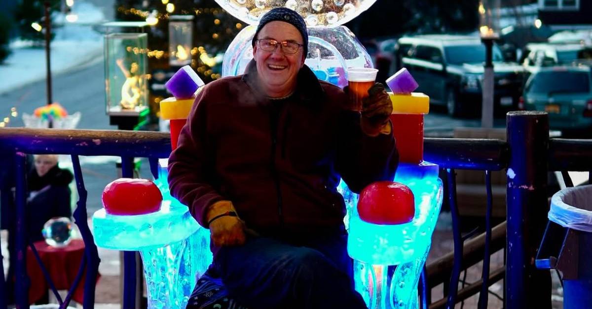 man with beer on ice sculpture chair
