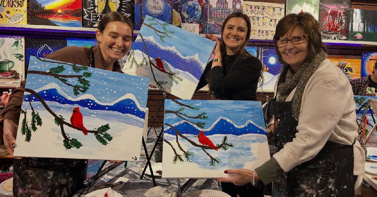three women holding bird painting