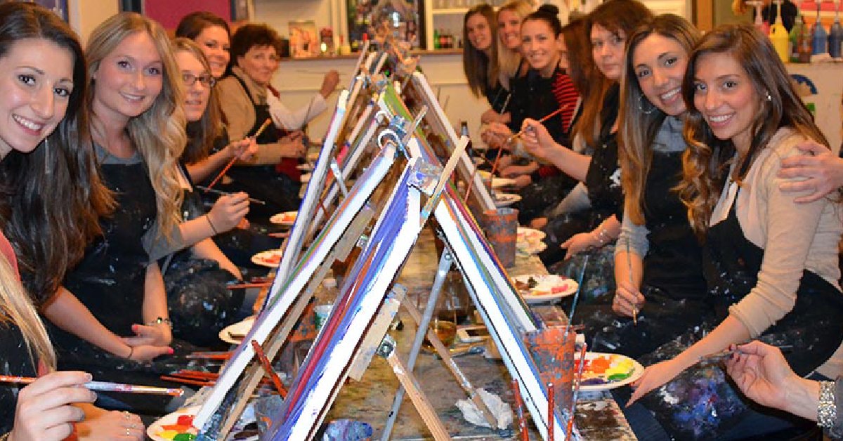 long table of women painting