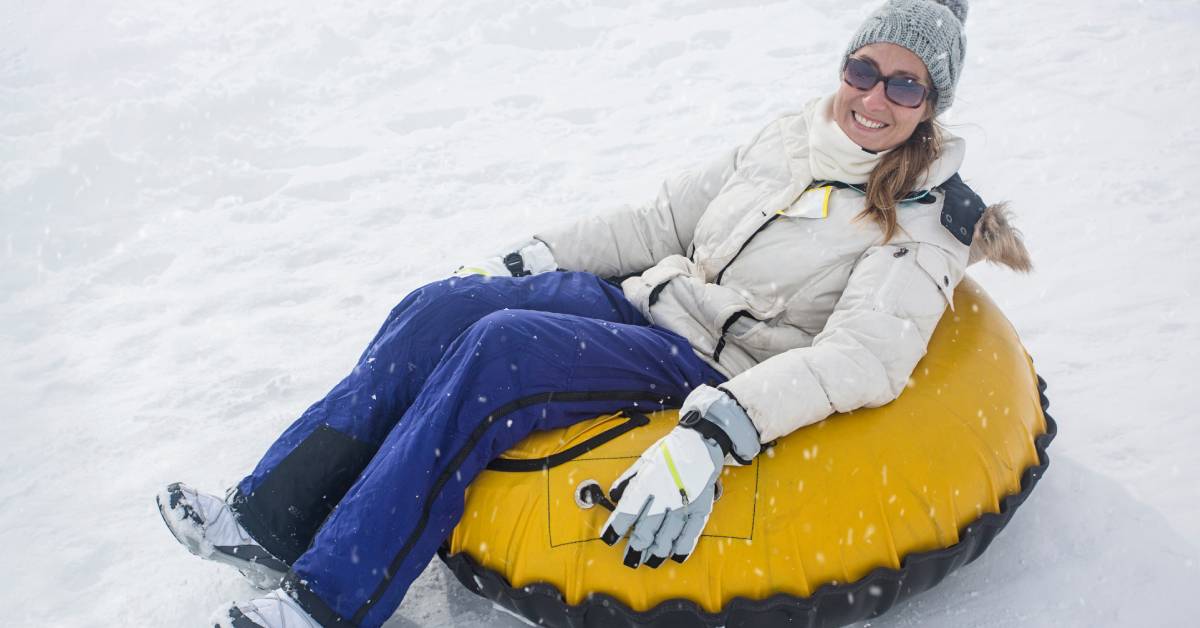 woman on a yellow snow tube