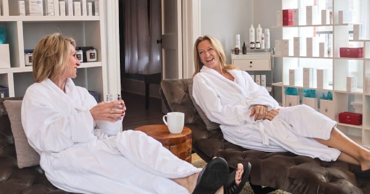 women laughing and lounging in robes
