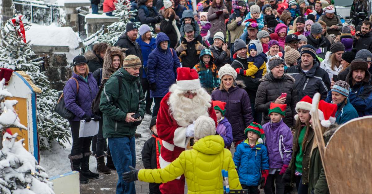 Santa meeting with people outside in a town event