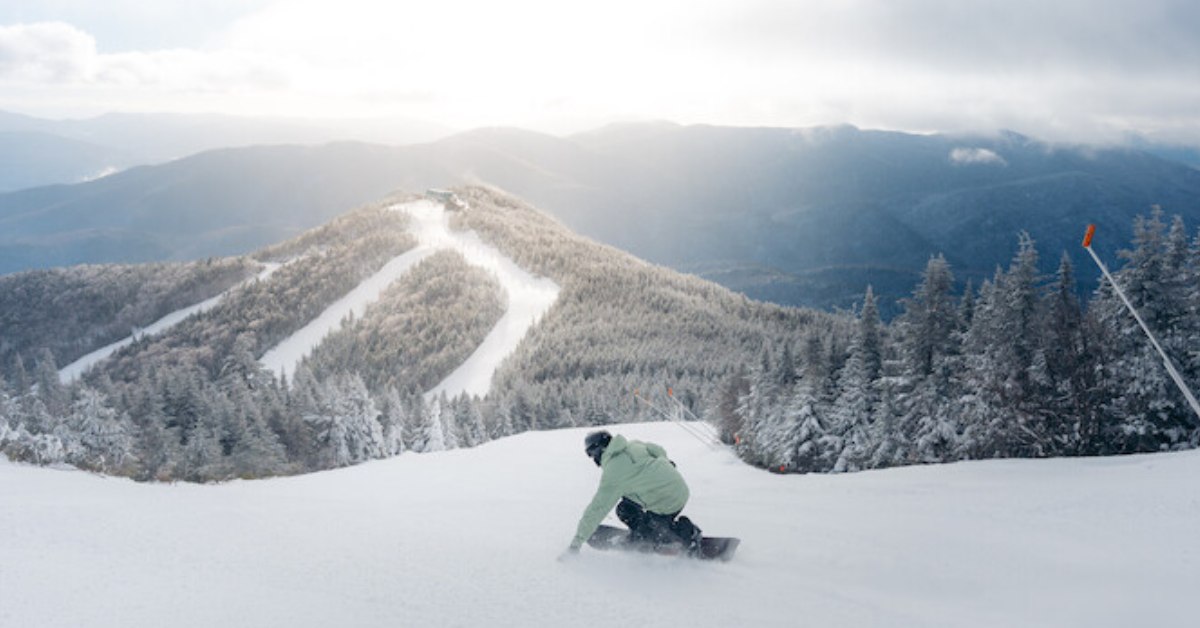 a snowboarder heading down a trail