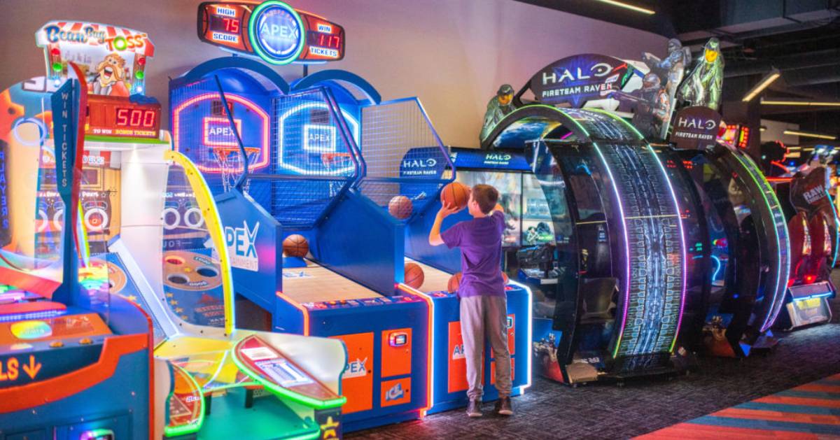 boy shooting basketball in an arcade game