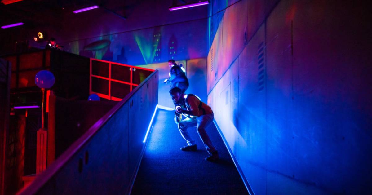 two people on a ramp in a laser tag arena