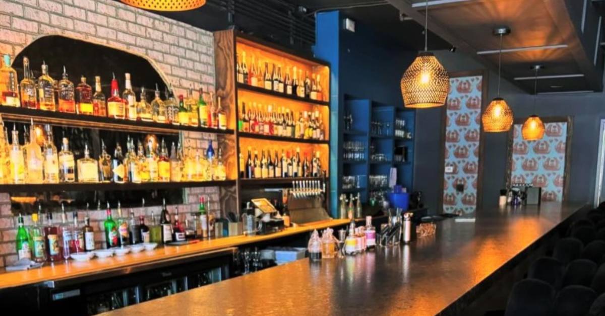 cocktail bar with liquor bottles on the wall