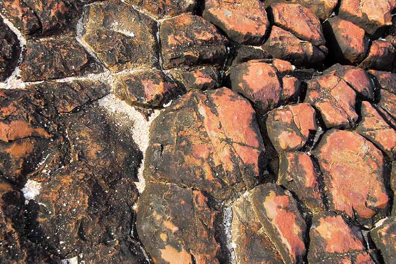 Igneous rock with red streaks likely to be garnet bearing