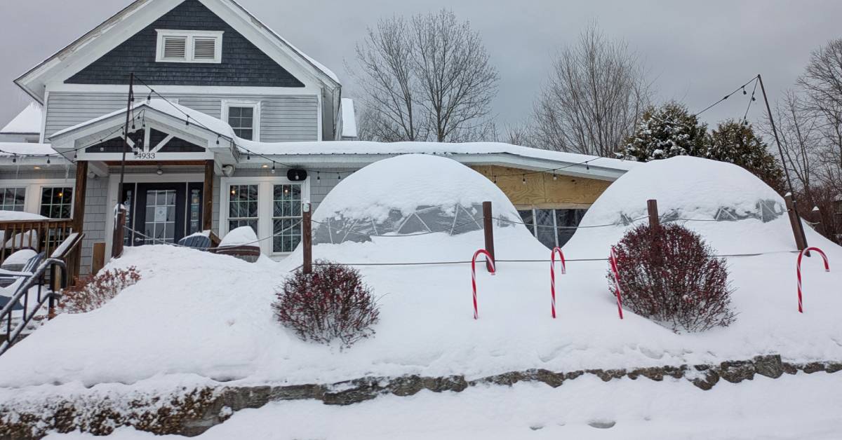 exterior of bolton landing brewing co in winter with dining igloos