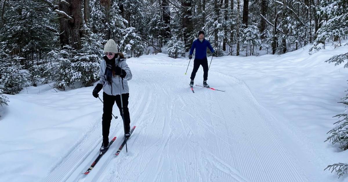 two people cross-country skiing