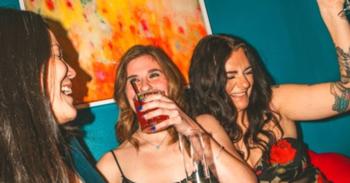 three women having fun in a cocktail bar