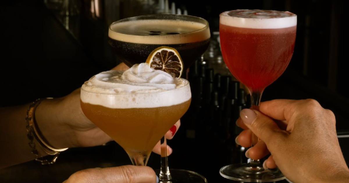 three people cheersing with cocktails